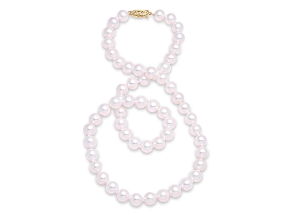 A long Mastoloni Pearls freshwater pearl necklace, named "Frshwater Pearl Pearl Necklace / 14 Kt Y /8.5MM," is laid out on a white surface. The necklace, with its 14 Kt gold clasp, is arranged in a loose and elegant serpentine shape, showcasing the shiny, round pearls.