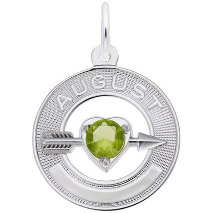 A circular silver pendant with the word "August" engraved at the top. At the center is a heart-shaped green peridot, representing the month's birthstone. An arrow runs through the gemstone horizontally. This August Love Birthstone Charm / Sterling Silver from Rembrandt Charms also features a small loop for a chain.