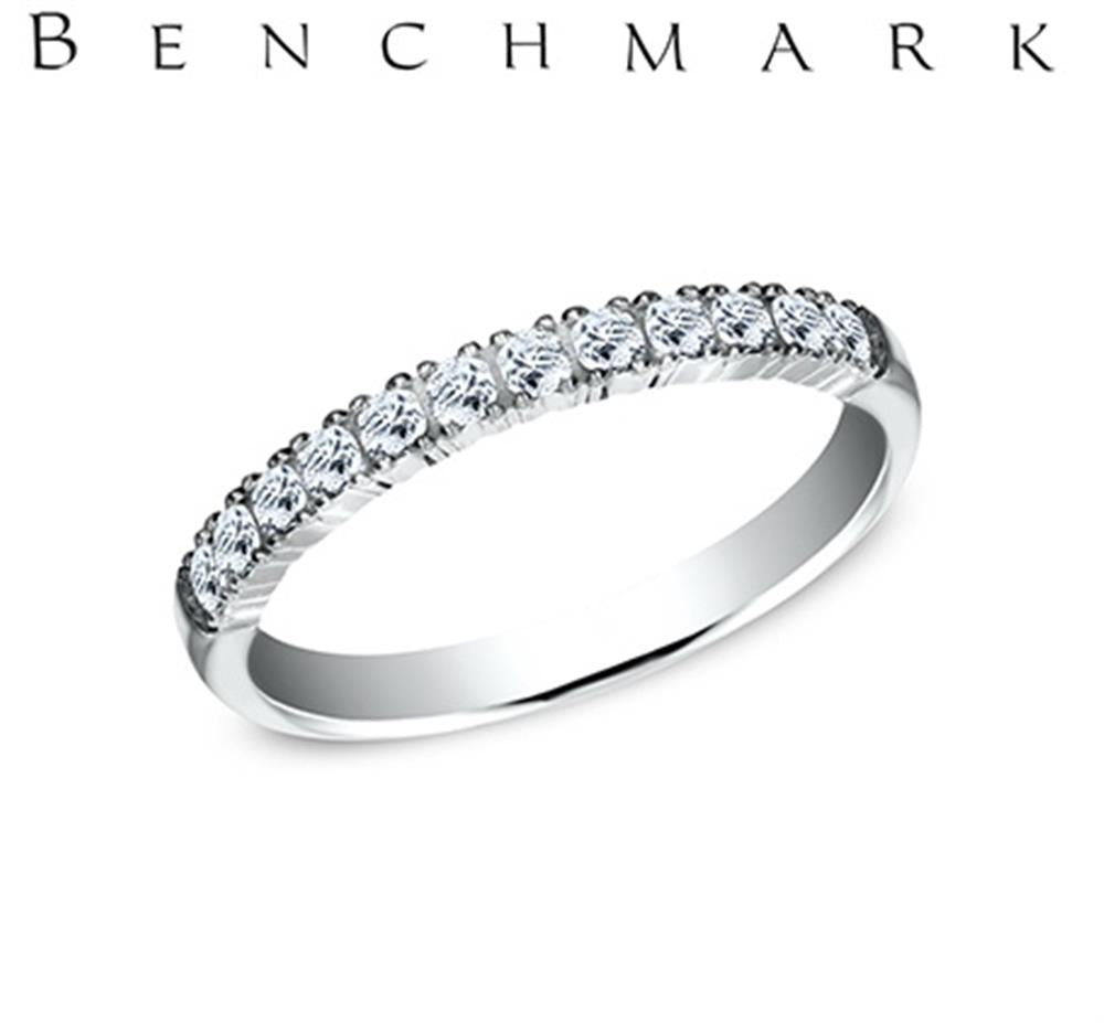 A stunning 14K white gold band, adorned with a row of small, sparkling lab-grown diamonds totaling 0.24 carats in French Stone Settings, is displayed against a white background. The word "BENCHMARK" is written above the ring in bold black capital letters. This elegant piece is part of the Benchmark Rings collection.