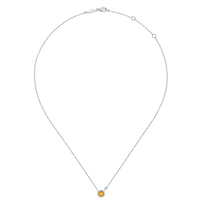 Introducing the Gabriel & Co 925 Sterling Silver Citrine and Diamond Pendant Necklace. This delicate piece features a small, round citrine gemstone, elegantly set in a minimalistic design. The thin sterling silver chain, which has a convenient clasp at the top, perfectly complements the sophisticated charm of this necklace.