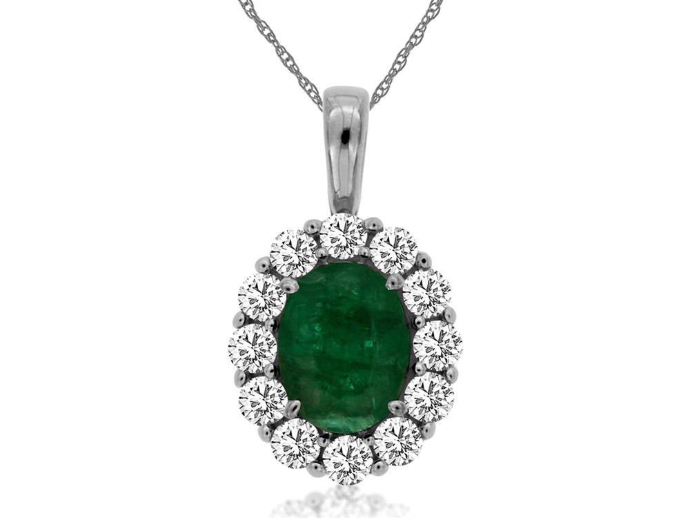 The Royal Jewelry "Emerald and diamond pendant" features a stunning silver necklace with an oval green emerald surrounded by a halo of brilliant diamonds. The delicate chain enhances the pendant's elegant design perfectly.