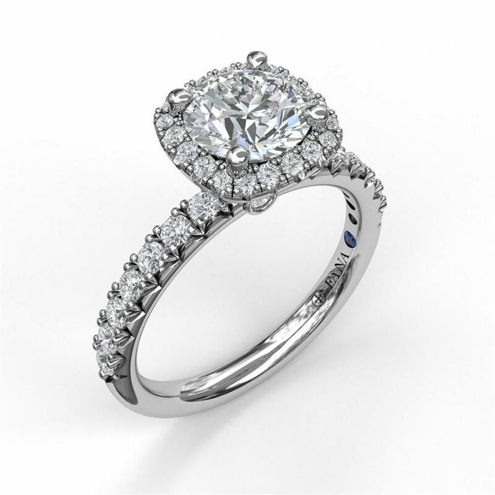 The FANA 14K White Gold Classic Round Diamond Halo Engagement Ring showcases a stunning round-cut diamond in a four-prong setting, surrounded by a halo of smaller conflict-free diamonds. The band is embellished with additional round diamonds, creating an unbroken sparkle around the ring.