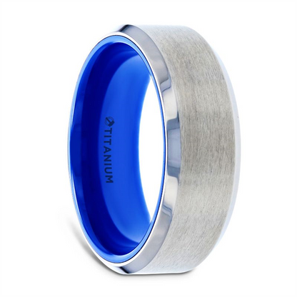 The Thorsten ARCTIC Flat Beveled Edges Titanium Ring showcases a brushed center with polished, beveled edges and a vibrant blue interior. The word "TITANIUM" is engraved on the blue inner band, adding to its modern, sleek design.