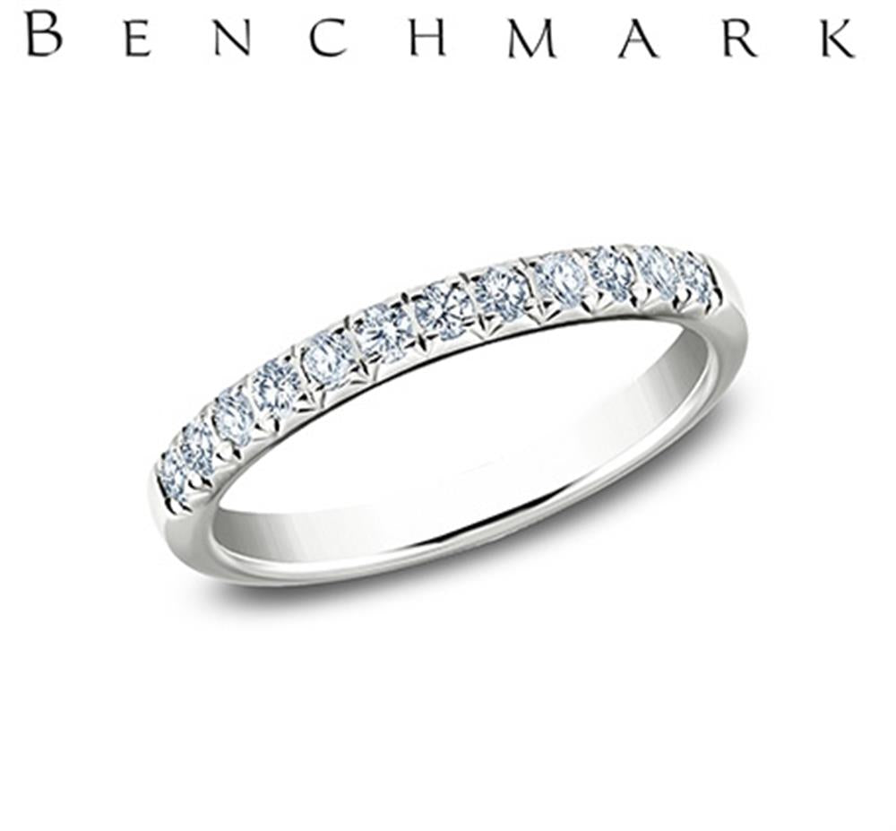 A 14K White Gold 0.24cts Lab Grown Diamond Butterfly Set Band from Benchmark Rings, encrusted with small lab-grown diamonds on the top half, is shown against a white background. The word "Benchmark" is written in large, elegant letters above the ring.