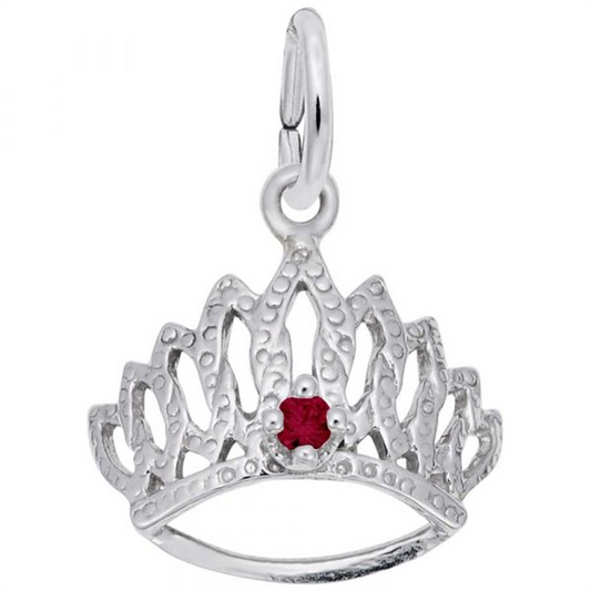 The "jan tiara" by Rembrandt Charms is a silver charm shaped like a tiara, featuring intricate designs and a small red gemstone at its center, elegantly hanging from a loop.