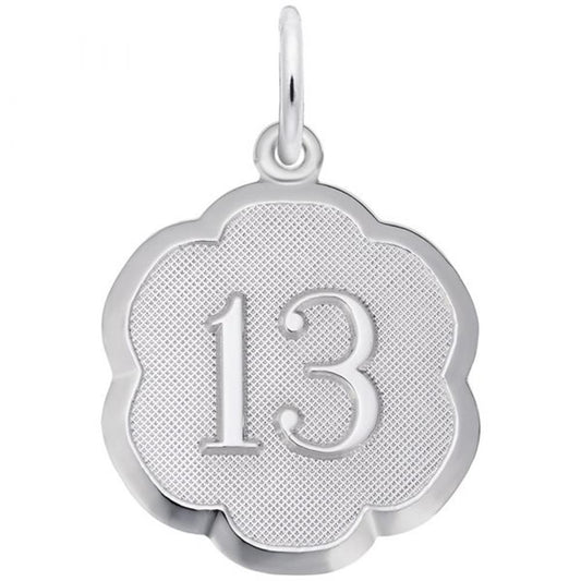 Introducing the Number 13 Charm by Rembrandt Charms: a sterling silver piece beautifully crafted in the shape of a flower, featuring a textured center and an engraved number "13". This elegant charm includes a small loop at the top, making it easy to attach to your favorite necklace or bracelet.