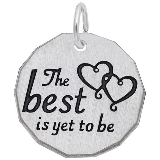 Rembrandt Charms' "The Best Is Yet To Be" sterling silver charm features two interlocking heart outlines and the engraved text "The Best Is Yet To Be." This round charm has a small hole at the top center with a metal ring attached.