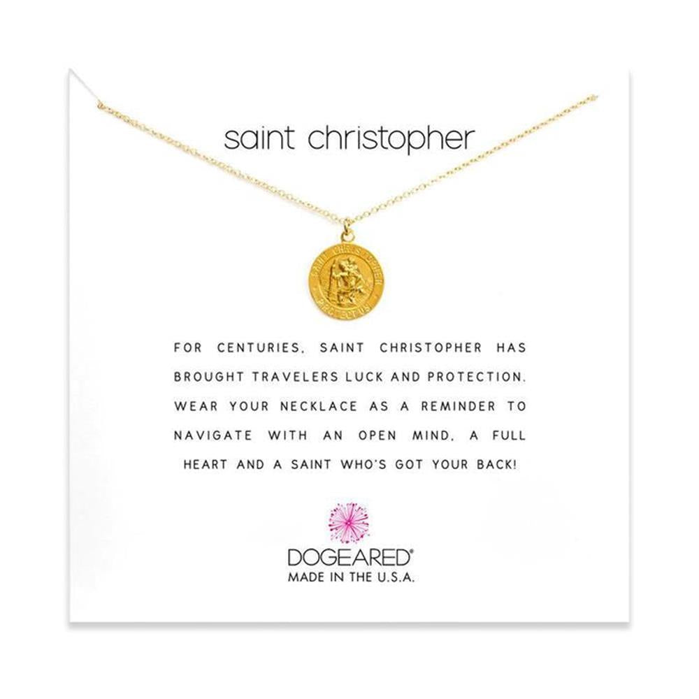 The Dogeared Saint Christopher /GP-SS / 18-inch gold circle pendant necklace is displayed against a white background. The card behind reads, "Saint Christopher" and describes the saint's protection for travelers. Below, "DogEared Made in the U.S.A." is printed.