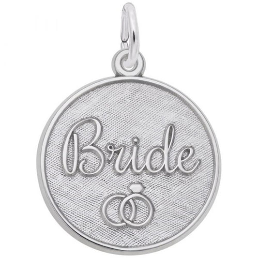 The Bride Engravable Disc Charm in sterling silver by Rembrandt Charms features a round pendant with a textured background. The word "Bride" is elegantly engraved in cursive at the center, accompanied by an image of two interlocked wedding rings below it. This charming piece includes a small loop at the top for easy attachment to a chain or bracelet.