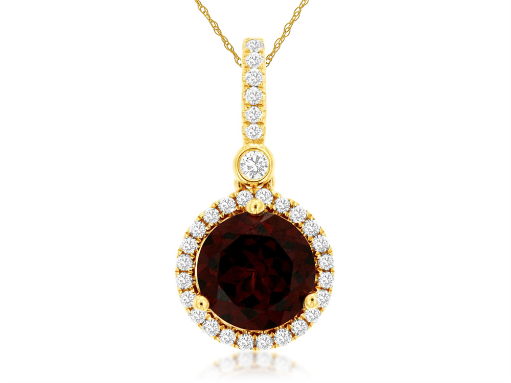 The Garnet and diamond pendant by Royal Jewelry is a captivating piece that highlights a gold necklace adorned with a large dark red gemstone centerpiece, surrounded by glittering diamonds and accented with an elegant diamond above. This exquisite pendant dangles beautifully from a delicate gold chain, radiating timeless elegance.