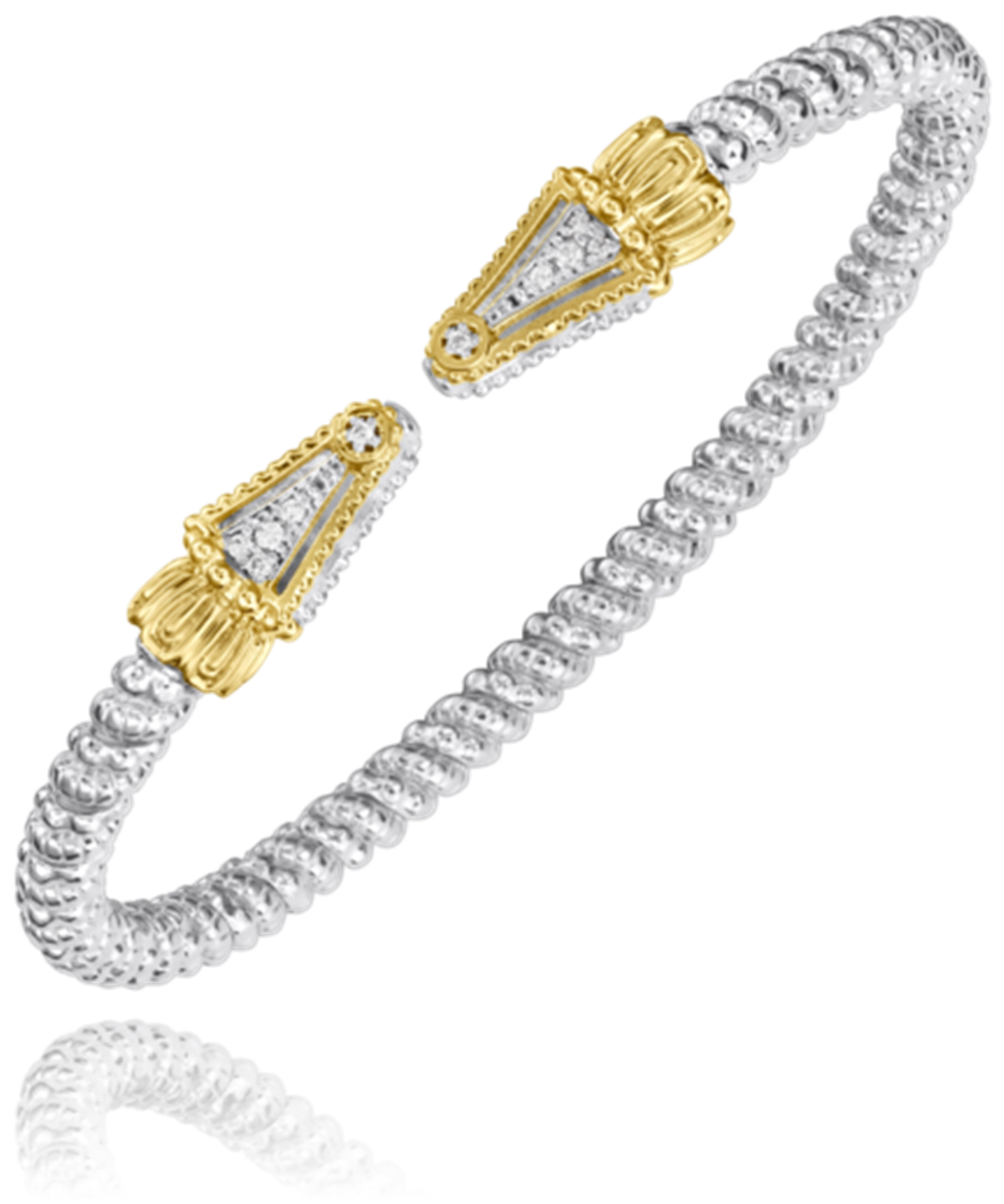 The Alwand Vahan Jewelry's 3MM SPIKE bracelet, crafted in silver with a twisted design and adorned with ornate gold caps featuring embedded clear gemstones at each end, adds a touch of elegance.