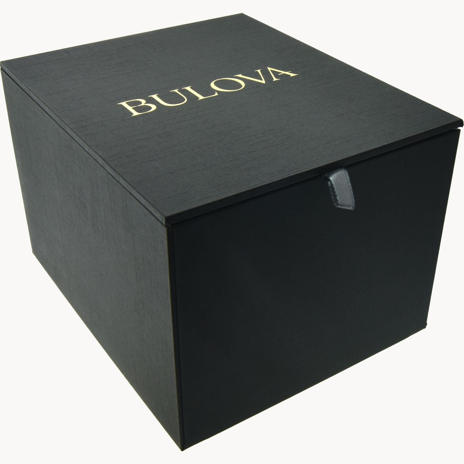 A black, cubic box with a leather-like texture. The word "Bulova" is printed in gold lettering on the top. Designed to hold the Marine Star Ladies' Watch with Mother of Pearl Dial from Bulova Watch Company, the box has a small, black pull-tab on the front for opening.