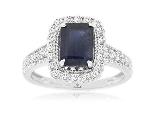 Introducing the Royal Jewelry's 14k WG Sapphire and Diamond ring, size 7: a sumptuous piece that features an emerald-cut sapphire at its center, encircled by a shimmering halo of round diamonds, all elegantly set on a 14k white gold band embellished with additional diamonds.