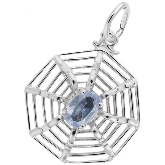 The Spider Web Charm from Rembrandt Charms is a sterling silver pendant with an octagonal design and intricate detailing, resembling a spider web. At its center is an oval-cut blue gemstone, likely a sapphire. This charming piece also includes a small loop at the top for attaching to a chain.