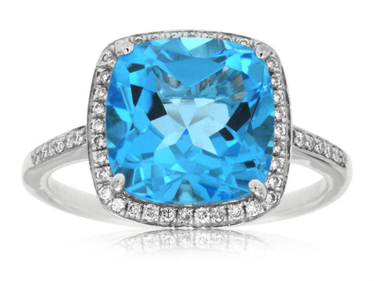 Presenting the Royal Jewelry 14k WG Blue Topaz and Diamond ring in size 7, a striking piece featuring a cushion-cut blue topaz at its center surrounded by a halo of dazzling white diamonds. The band is gracefully embellished with small diamonds, enhancing the brilliance of this exquisite design.