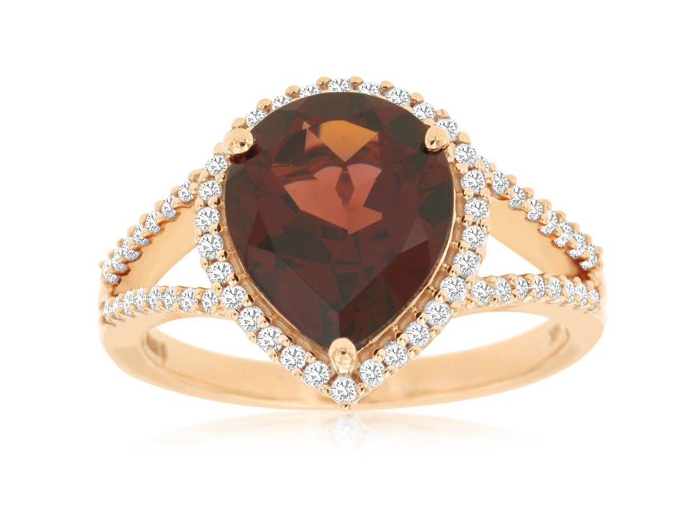 This exquisite piece, the 14k RG Garnet and Diamond Ring from Royal Jewelry, features a stunning teardrop-shaped brown garnet at its center. Encircled by a halo of dazzling diamonds, this ring's band is further lined with additional diamonds to enhance its sparkle and elegance. Style # PC6545G, available in size 7.