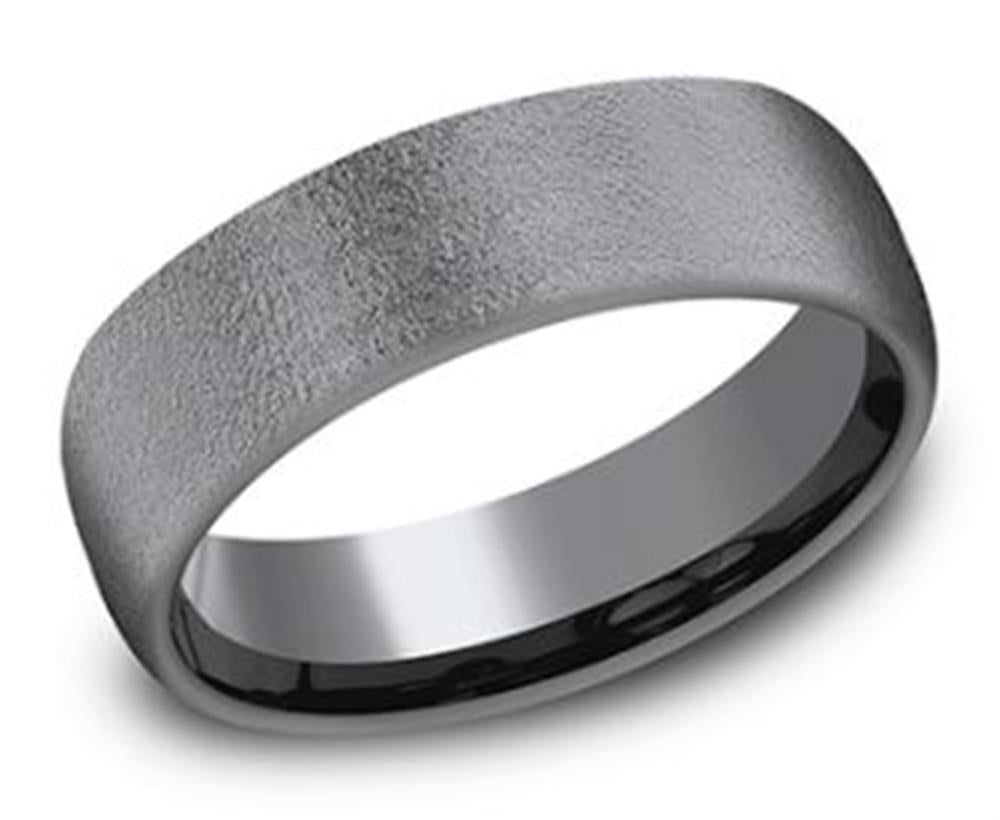 A close-up image of the 6.5mm Tantalum Wire Brush Textured Ring by Benchmark Rings shows its smooth, matte silver appearance with a slightly wider band. The inner surface is glossy and reflective, creating a striking contrast with the wire-brushed textured outer surface. This comfort-fit ring combines simplicity and elegance in its design.