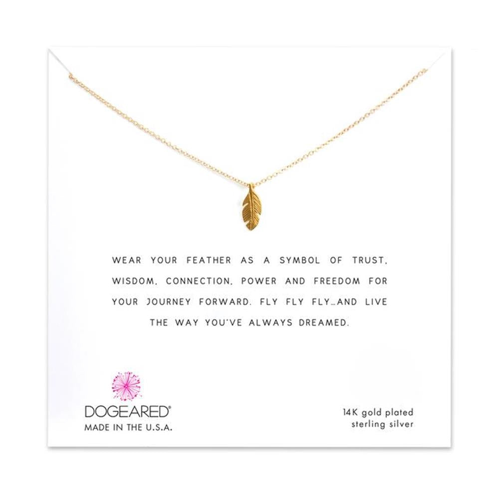 A gold-plated Feather Life Journey Necklace (GP-SS) with a feather pendant displayed on a white card. The card reads: "Wear your feather as a symbol of trust, wisdom, connection, power and freedom for your journey forward. Fly fly fly... and live the way you've always dreamed." Made by Dogeared.