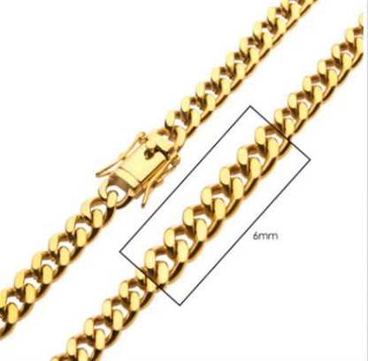 A close-up image of the 6mm 18K Gold Plated Miami Cuban Chain by INOX highlights its gold chain with interlocking links. This men's necklace, labeled as 18K gold plated and measuring 22 inches in length, features a clasp designed for secure fastening.