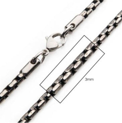 A close-up of the 3mm Oxidized Steel Boston Link Chain by INOX, showcasing its unique rectangular link design and secure lobster clasp. The men's 22" necklace is highlighted with a measurement graphic overlay to emphasize its 3mm width.