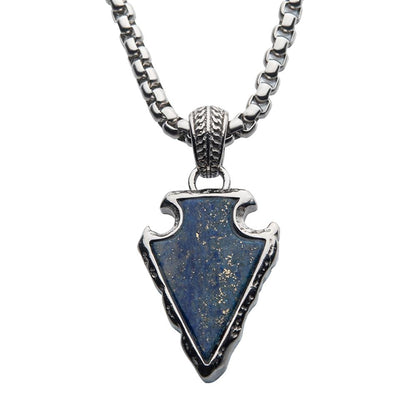 The Lapis Lazuli Stone with Polished Steel Frame Pendant with Polished Steel Box Chain by INOX features a men's 24-inch box chain adorned with a silver arrowhead-shaped pendant. The center is set with a stunning blue, speckled lapis lazuli stone, bezel-set in silver and embellished with decorative metalwork and polished steel, making it a striking accessory for any occasion.