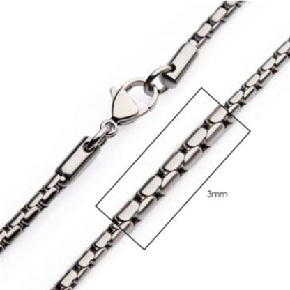 A close-up image of the 3mm Steel Boston Link Chain by INOX, measuring 24 inches. The stainless steel chain features interlocking rectangular links and is secured with a lobster clasp. A section is highlighted in a rectangle to emphasize its width.