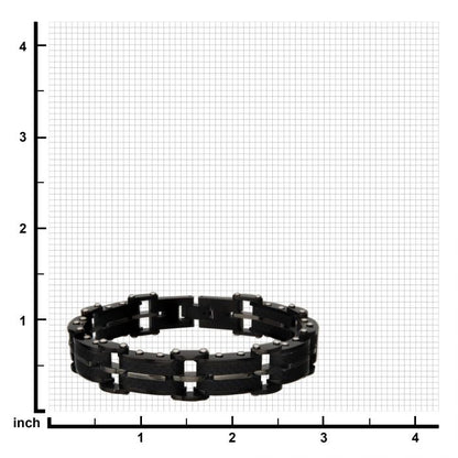 The Men's Black Carbon Fiber and Gold-Plated ID Link Bracelet by INOX, designed with interlocking segments to resemble a machinery chain, is centered on a gray grid background marked with inch measurements along the x and y axes. The bracelet lies flat on the grid.