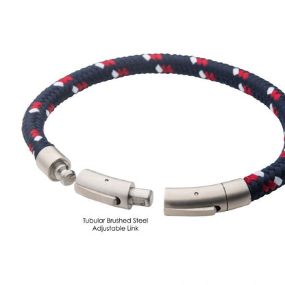 The INOX 6mm Blue, White, and Red Nylon Cord Bracelet, featuring a tubular brushed steel clasp and adjustable links, is displayed, showcasing its braided navy blue, red, and white nylon cord design.