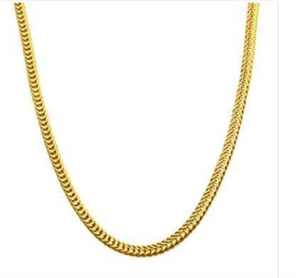 A close-up image showcasing the 6mm 18K Gold Plated Foxtail Chain by INOX, featuring interconnected links that create a sleek and polished design. The plain white background accentuates the necklace's shiny and luxurious texture, highlighting its smooth and elegant appearance.