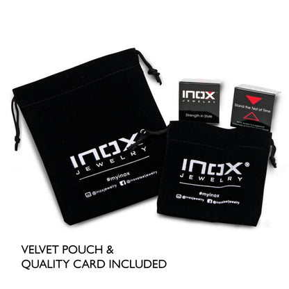 Image showing two black velvet pouches with "INOX Jewelry" branding in white text. The larger pouch is on the left and the smaller one on the right. Two small product boxes and a quality card are positioned above the pouches. Text reads "VELVET POUCH & QUALITY CARD INCLUDED" – perfect for your 6mm Blue, White and Red Nylon Cord Bracelet purchase from INOX.