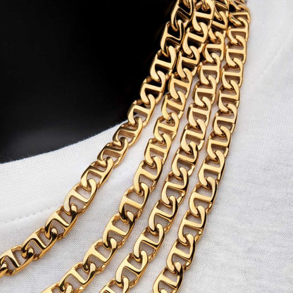 Close-up of four INOX 8mm 18K Gold Plated Mariner Link Chains, each measuring 24 inches, displayed against a white fabric background. The chains feature a shiny, polished finish and are layered to highlight their intricate design.