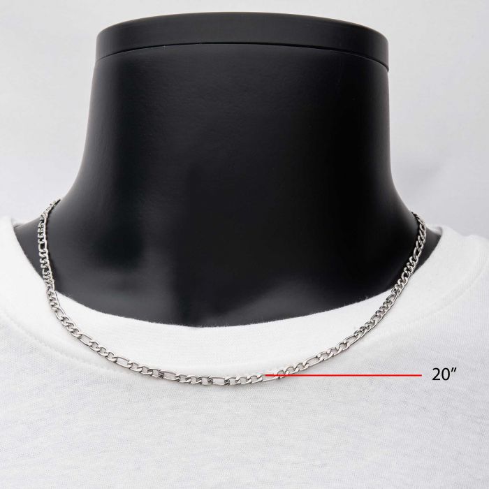 A silver 4mm Steel Figaro Chain from INOX, measuring 20 inches, displayed on a black mannequin neck against a white background. The mannequin is dressed in a white shirt, and a red line with the text "20"" indicates the length of the men's stainless steel chain.