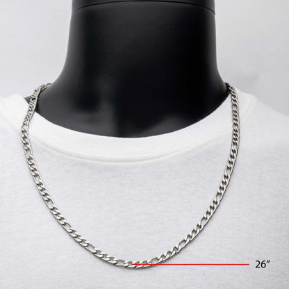 An elegant men's necklace, the 6mm Steel Figaro Chain by INOX, is showcased on a black mannequin dressed in a white shirt. The image distinctly highlights the chain's length of 22 inches using text and a measurement line.