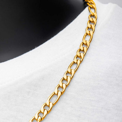 A close-up image of the INOX 8mm 18K Gold Plated Figaro Chain Necklace, measuring 22 inches in length, draped over a white garment. The gold plated links form a consistent pattern that complements the stainless steel base. The white fabric contrasts beautifully with the shiny gold, highlighting the necklace's vibrant color and elegant design.