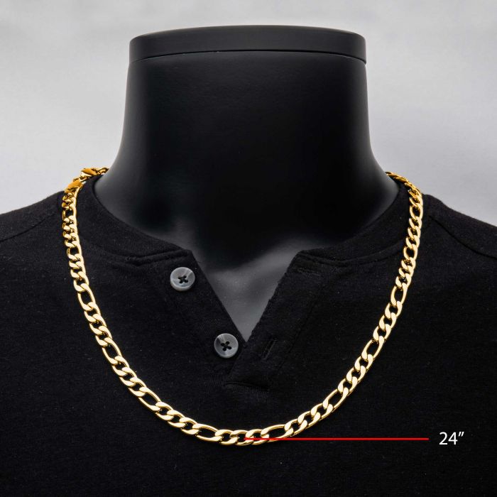 An INOX men's stainless steel 8mm Figaro chain necklace plated in 18K gold is showcased on a black mannequin torso wearing a black buttoned shirt. The chain, labeled in the image with red text and an arrow, measures 22 inches in length.