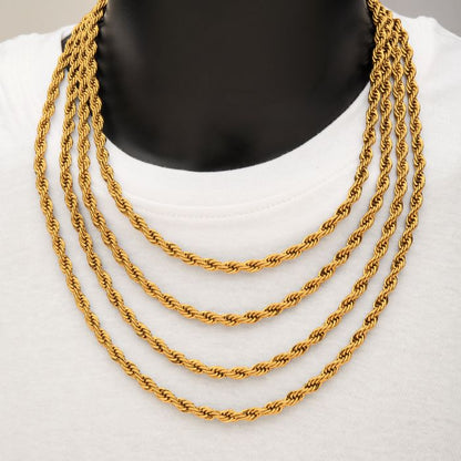 A black mannequin wears a white shirt and displays a stunning four-layered, twisted rope gold plated men's necklace. The chains, made from durable stainless steel and branded as the 6mm 18K Gold Plated Rope Chain by INOX, vary in length, with each layer slightly longer than the one above it, creating a cascading effect.