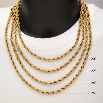 A close-up of a person wearing a white top and four INOX 6mm 18K gold plated rope chains in stainless steel, each measuring 20 inches, 22 inches, 24 inches, and 26 inches, positioned slightly lower than the previous one.