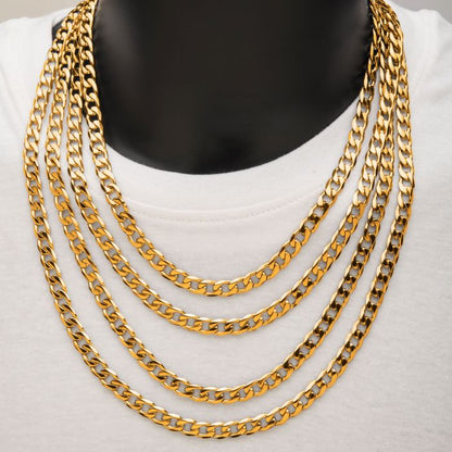 Close-up of a mannequin's neck adorned with the INOX 8mm 18K Gold Plated Bevel Curb Chain necklace. The chains vary in length, draping gracefully over a plain white shirt to create a bold and elegant look. The unobtrusive background ensures that the focus remains on the stunning jewelry.