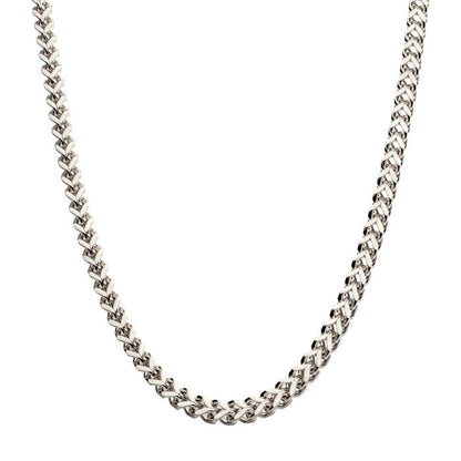 A close-up image of the 6mm Steel Franco Chain by INOX highlights its sleek silver finish. The men's stainless steel necklace features interlocking V-shaped links, creating a polished texture. The 20" chain forms a gentle curve, showcasing its elegant and classic design against a plain white background.