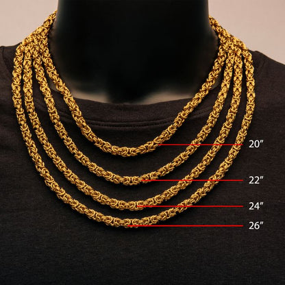 A mannequin displays four premium necklaces of varying lengths: 20 inches, 22 inches, 24 inches, and 26 inches. Among them is the exquisite INOX 6mm 18K Gold Plated King Byzantine chain necklace. Layered over a black shirt, the lengths are marked by red lines and corresponding labels for easy reference.