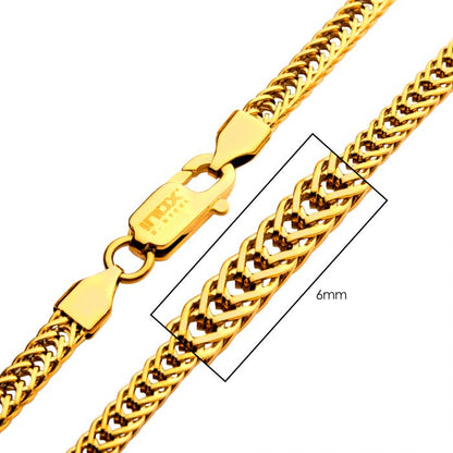 A close-up image of the 6mm 18K Gold Plated Foxtail Chain from INOX, featuring an intricate braided design. The men's stainless steel necklace has a lobster clasp for fastening and measures 22 inches in length.