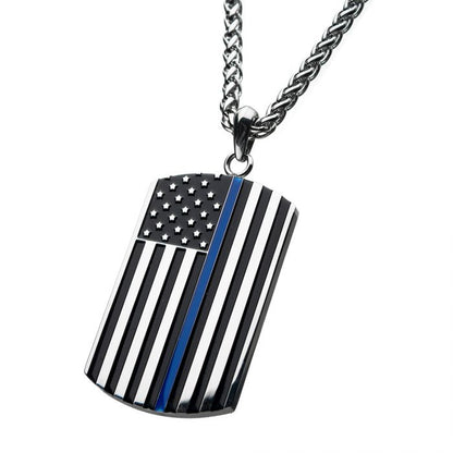 An American Flag Police Officer Military Style Dog Tag Enamel Pendant with Chain by INOX features a pendant resembling a military dog tag, showcasing a stylized monochrome American flag with a single blue stripe running vertically near the center. The background is white.