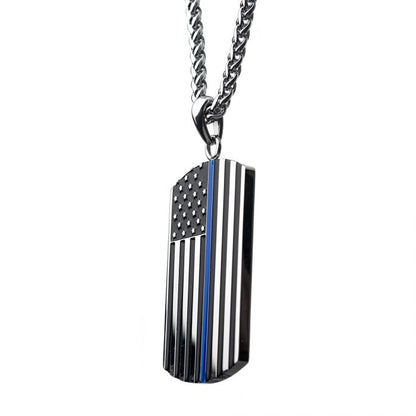 The American Flag Police Officer Military Style Dog Tag Enamel Pendant with Chain by INOX is a silver-colored metal necklace featuring a rectangular pendant designed as a black-and-white American flag. A single blue stripe runs vertically through the center, symbolizing the Thin Blue Line, and serving as a tribute to the dedication of police officers.