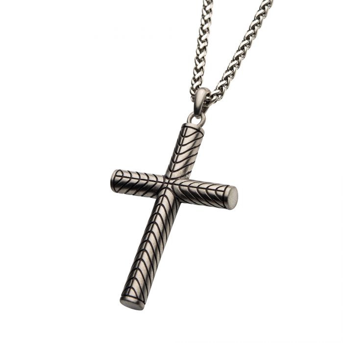 The INOX Steel Geometric Pattern Cross Pendant, featuring diagonal stripe engravings, hangs elegantly from a matching steel wheat chain. The plain white background enhances the intricate design and geometric pattern of the cross.