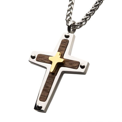 The 18K Gold Plated Cross Overlapped on a Steel Pendant with Walnut Wood from INOX features a distinctive small men's cross plated in 18K gold, set against dark walnut wood inlay with metal rivet details, and comes with a 24" silver chain.