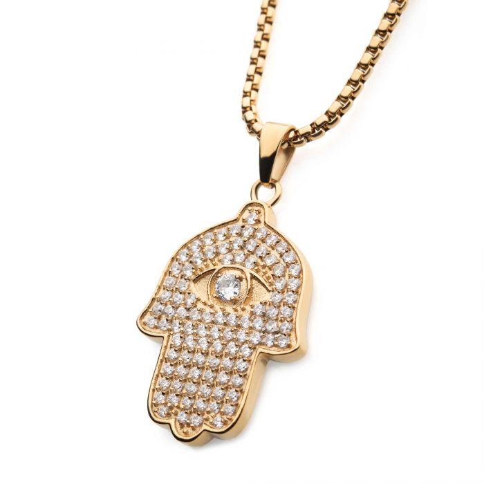 A stunning piece from INOX, the 18K Gold Plated CZ Hamsa Pendant on a 22" gold plated box chain features an intricately designed Hamsa encrusted with numerous small AAA CZ diamonds. The pendant depicts an eye in the center adorned with a single diamond, symbolizing protection and good fortune. Set against a plain white background, this exquisite accessory exudes elegance and charm.