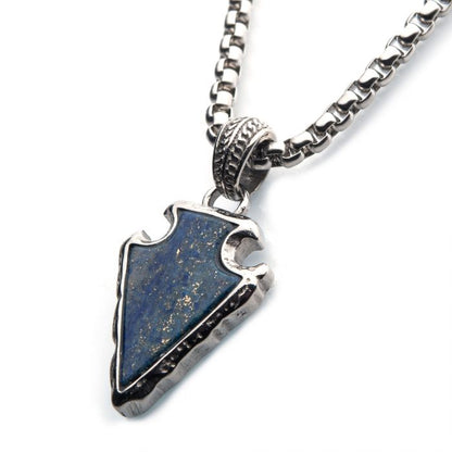 The Lapis Lazuli Stone with Polished Steel Frame Pendant from INOX features a gold-speckled lapis lazuli arrowhead, set in an ornate polished steel frame. The pendant comes on a thick, 24-inch polished steel box chain.